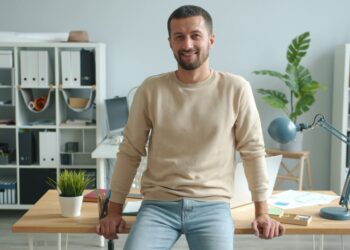 A focused entrepreneur working at a co-working desk in a modern London flexible workspace