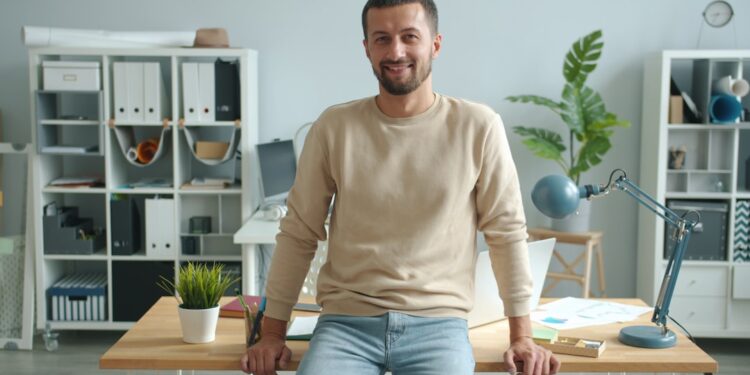A focused entrepreneur working at a co-working desk in a modern London flexible workspace
