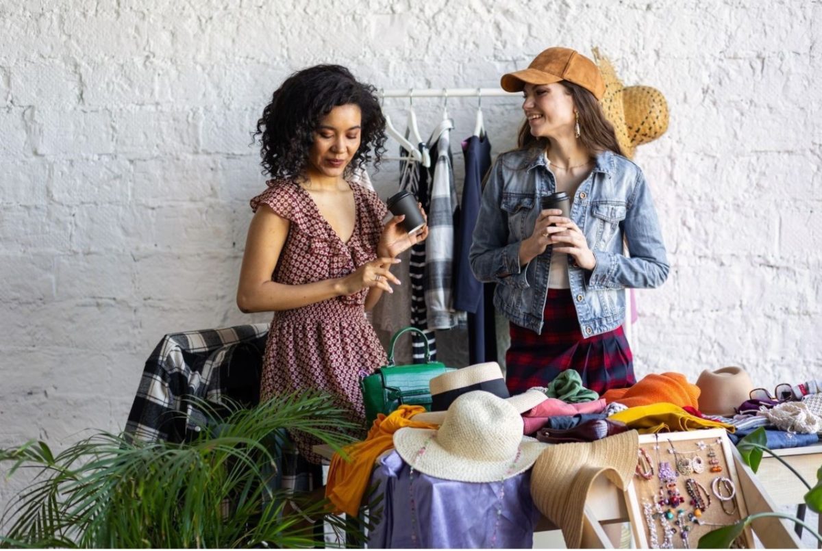 Friends exploring a market stall at vintage shops in Hackney east London