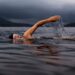 outdoor-swimming-woman-unsplash - LONDONwebzine A woman enjoying wild swimming in a calm outdoor pond surrounded by greenery in London
