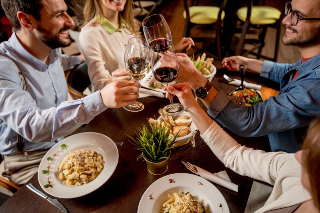 people eating and drinking wine in restaurant in London