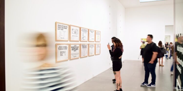 visitor-looking-at-large-sculpture-gallery-unsplash - LONDONwebzine A visitor stands before a large mirror sculpture at the Anish Kapoor exhibition at the Hayward Gallery, Southbank London