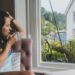woman-train-window-english-countryside-unsplash - LONDONwebzine A woman gazes from a train window during one of many possible day trips from London into the English countryside
