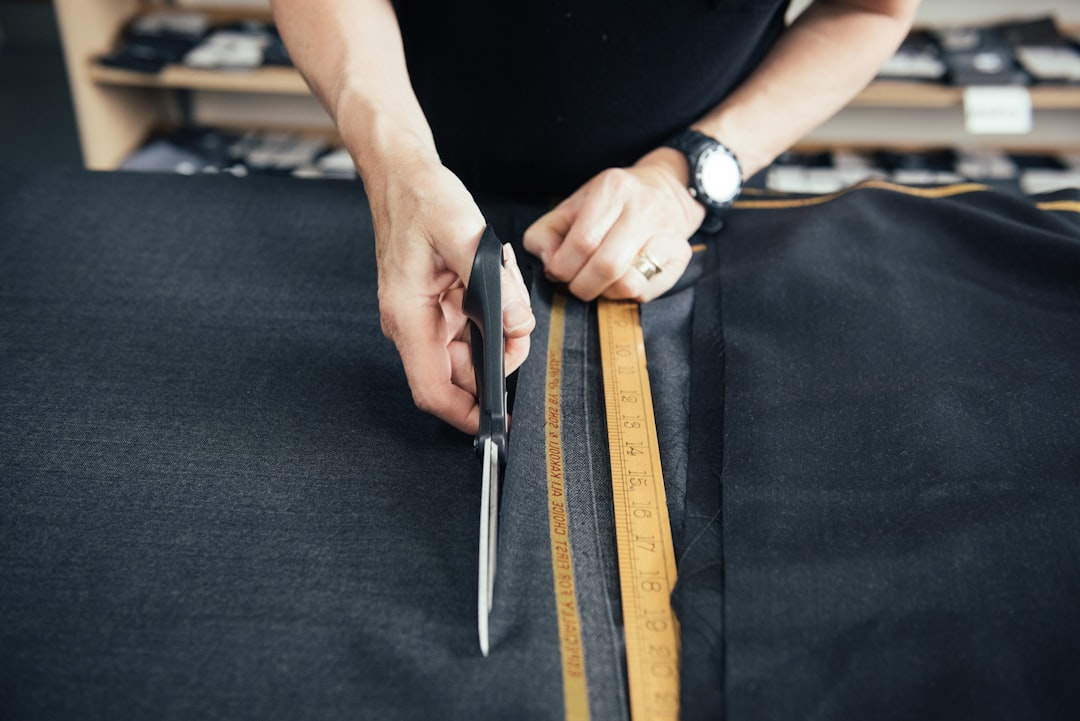 An artisan cuts natural fabric by hand in a London studio that champions slow fashion production