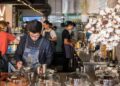 A barista crafts latte art at one of London's best independent coffee roasters, showcasing the specialty in every cup.