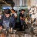 barista-in-a-cafe-unsplash - LONDONwebzine A barista crafts latte art at one of London's best independent coffee roasters, showcasing the specialty in every cup.