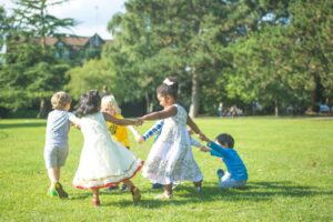 children running through a green Royal Park in London, enjoying free outdoor activities for London kids during the summer.