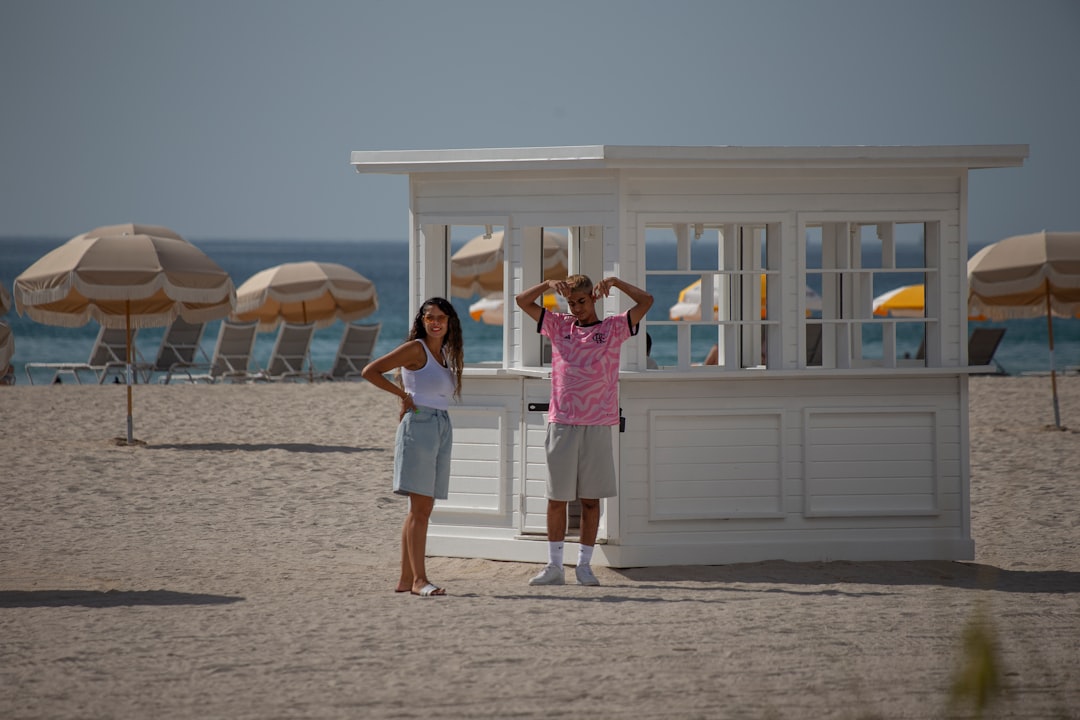A couple enjoys fresh oysters at a colourful beach hut during a weekend coastal escape from London.