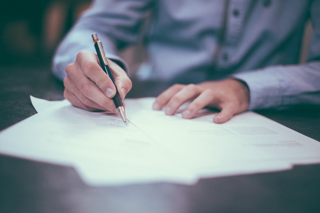 A London entrepreneur reviewing and signing venture capital term sheet documents with an advisor