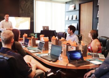 A first-time founder presenting his startup pitch to a venture capital investor in a London office