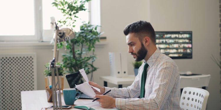 founder-signing-business-documents-desk-unsplash - LONDONwebzine A first-time founder signs incorporation documents during the limited company registration process in London