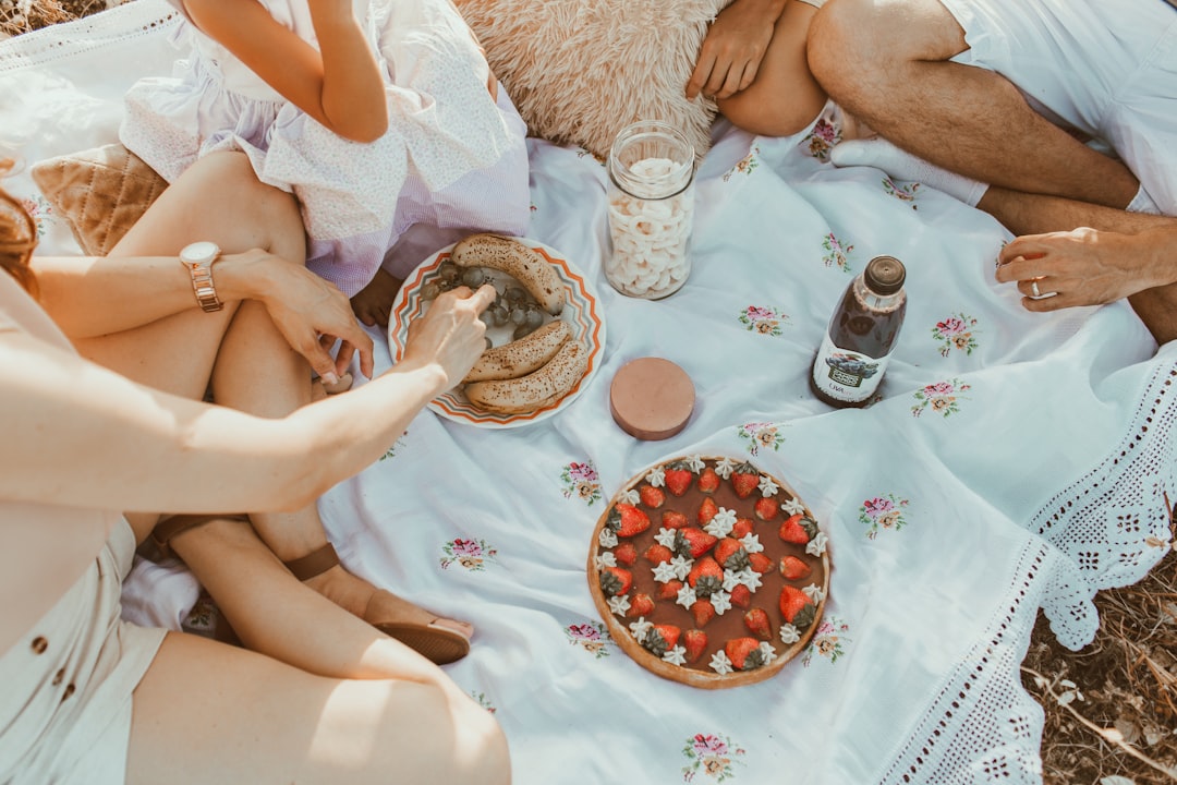 A group of friends enjoying strawberries and cream at a London pub garden during Wimbledon finals week