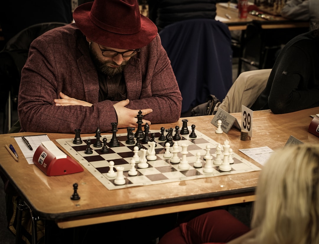 A grandmaster gives a simultaneous display at ChessFest London surrounded by seated players