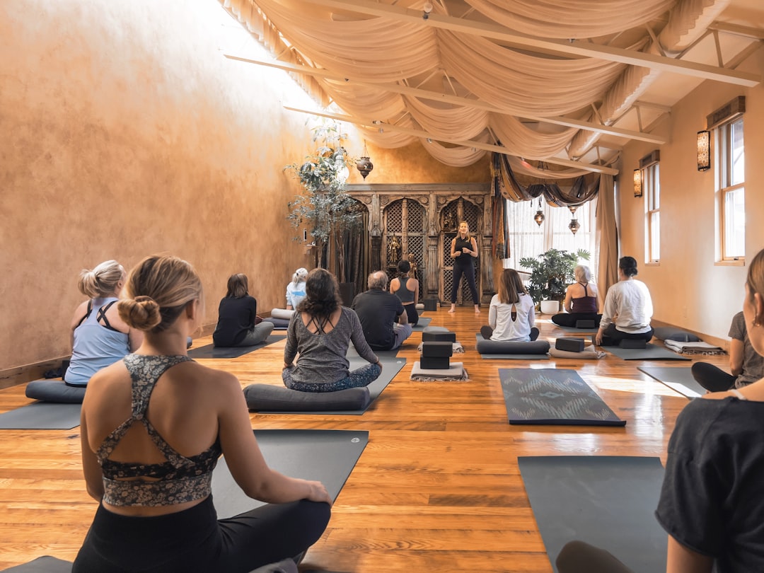 A group of people seated in a circle during a session at a breathwork studios class in London, guided by an instructor.