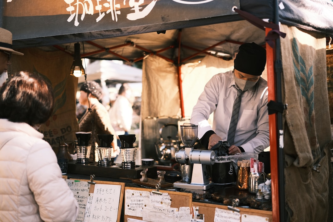 A coffee lover browses bags of beans at a London street market stall run by an independent coffee roasters brand.