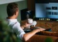 man-watching-golf-pub-tv-unsplash - LONDONwebzine A London golf fan watching the Open Championship leaderboard on a pub screen in the city