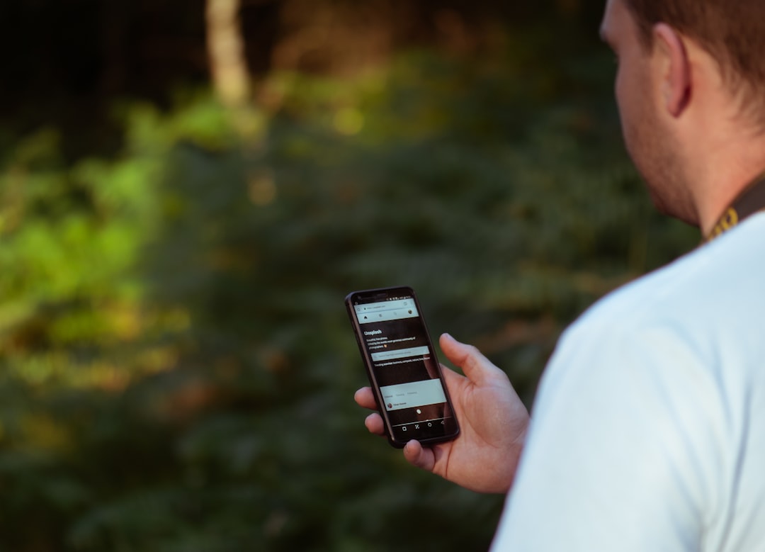 A London golf fan checking the Open Championship leaderboard and streaming updates on a mobile app