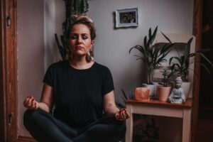 A woman practising conscious breathing in one of London's leading breathwork studios, lying on a mat in a softly lit room.