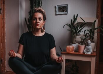 A woman practising conscious breathing in one of London's leading breathwork studios, lying on a mat in a softly lit room.
