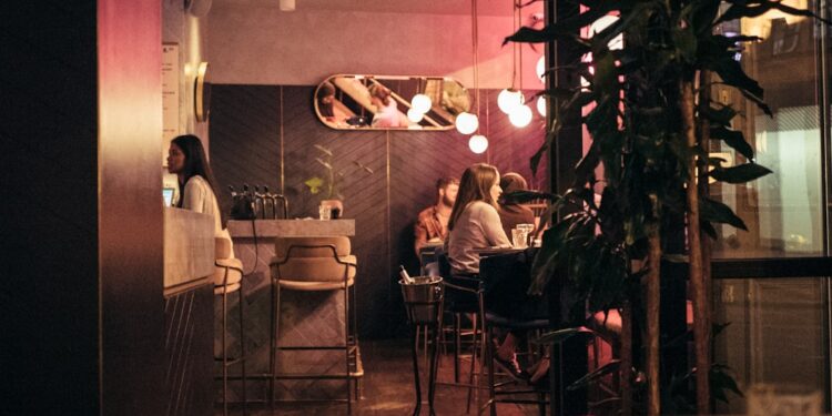 woman-dining-luxury-london-restaurant-unsplash - LONDONwebzine A woman enjoying exclusive dining at one of London's top members clubs, surrounded by elegant interiors