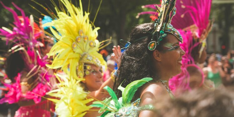 carnival-parade-dancer-costume-unsplash - LONDONwebzine A costumed dancer performing at Notting Hill Carnival in front of crowds on Ladbroke Grove