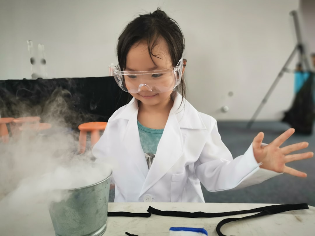Two children conduct a hands-on science experiment at an interactive exhibit in a London children's museum