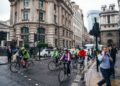 cyclist-group-road-london-smiling-unsplash - LONDONwebzine A group of beginners setting off on a road cycling club ride through a London park on a sunny morning