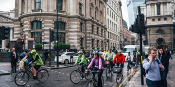 cyclist-group-road-london-smiling-unsplash - LONDONwebzine A group of beginners setting off on a road cycling club ride through a London park on a sunny morning
