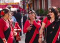 desi-woman-celebrating-street-unsplash - LONDONwebzine A South Asian woman in traditional dress celebrates Independence Day at a community event in London
