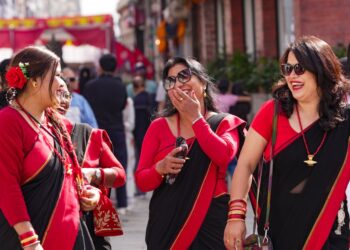 A South Asian woman in traditional dress celebrates Independence Day at a community event in London