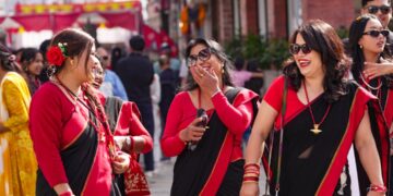 desi-woman-celebrating-street-unsplash - LONDONwebzine A South Asian woman in traditional dress celebrates Independence Day at a community event in London