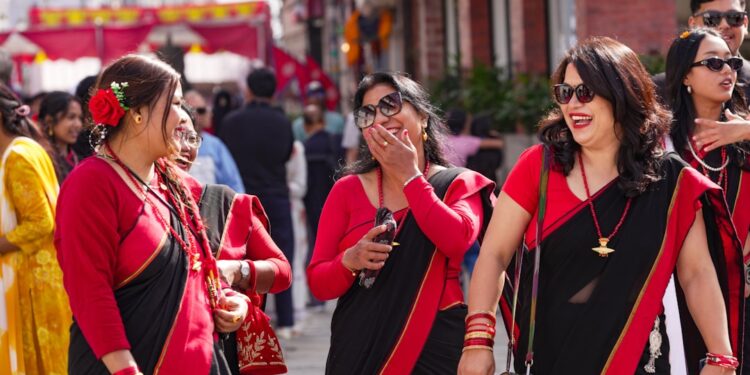 desi-woman-celebrating-street-unsplash - LONDONwebzine A South Asian woman in traditional dress celebrates Independence Day at a community event in London