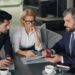 A financial advisor in a London office explains how to open a stocks ISA to a client across the desk