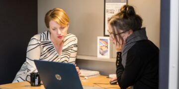 london-accountant-reviewing-documents-desk-unsplash - LONDONwebzine A London finance director conducts a business audit at her office desk in the City, reviewing financial records before Q4.