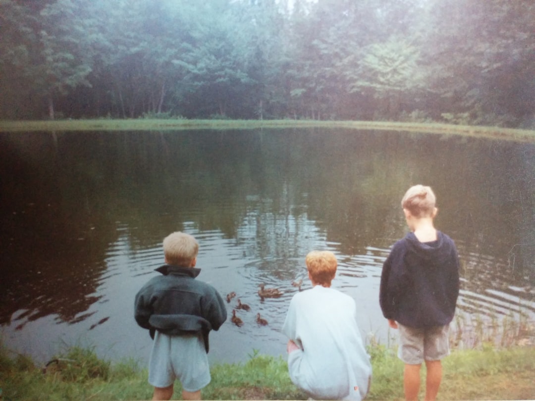 A group of swimmers gathering at an outdoor pond in London, ready for a cold water swimming session together