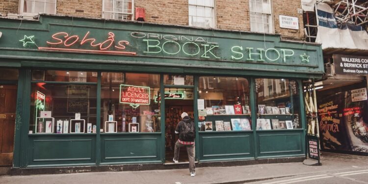 A woman carefully browses shelves inside one of London's independent bookshops on a summer afternoon