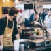 vendor-serving-food-borough-market-london-unsplash - LONDONwebzine A vendor hands a customer fresh street food at Borough Market, one of London's most celebrated street food destinations.