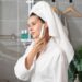 woman-applying-face-cleanser-bathroom-unsplash - LONDONwebzine A woman applying a minimal skincare cleanser at her bathroom mirror, representing a simple London indie beauty routine