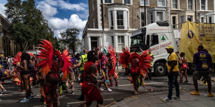 woman-dancing-notting-hill-carnival-unsplash - LONDONwebzine A woman in a colourful costume dancing at the Notting Hill Carnival during the bank holiday weekend in London