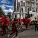 A woman in a colourful costume dancing at the Notting Hill Carnival during the bank holiday weekend in London