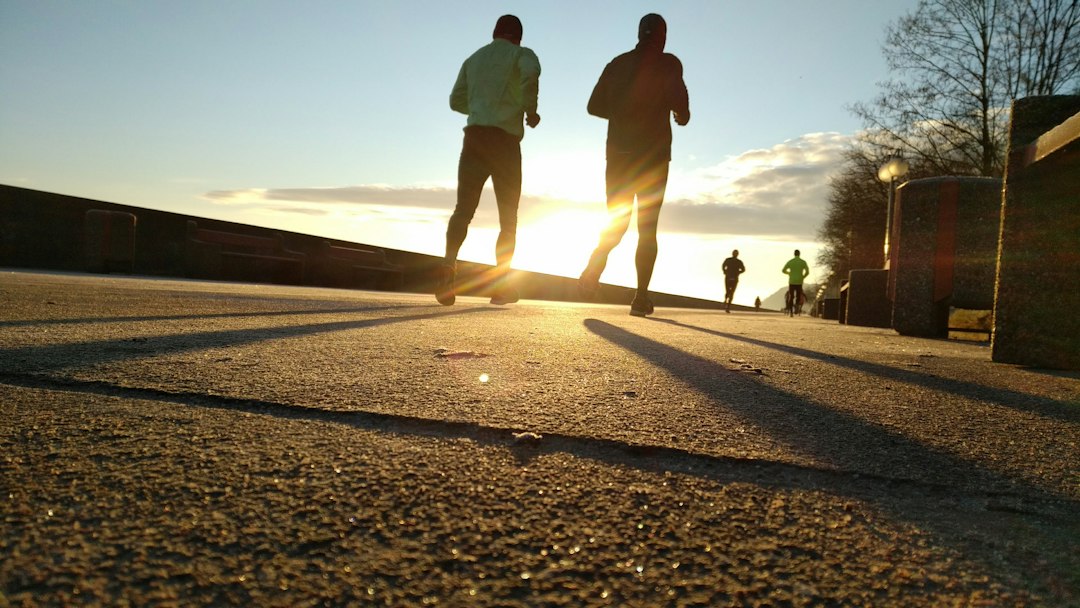 A beginner runner crosses the finish line at a Saturday morning parkrun event, showing the welcoming community.