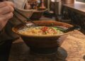A chef ladles rich tonkotsu broth into a bowl at one of London's top ramen restaurants