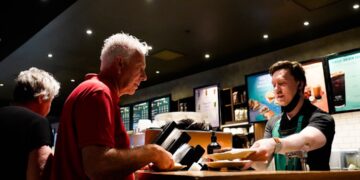 man-buying-cinema-tickets-unsplash - LONDONwebzine A man purchasing tickets at the counter of one of London's independent London cinemas, smiling at the staff member