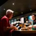 man-buying-cinema-tickets-unsplash - LONDONwebzine A man purchasing tickets at the counter of one of London's independent London cinemas, smiling at the staff member