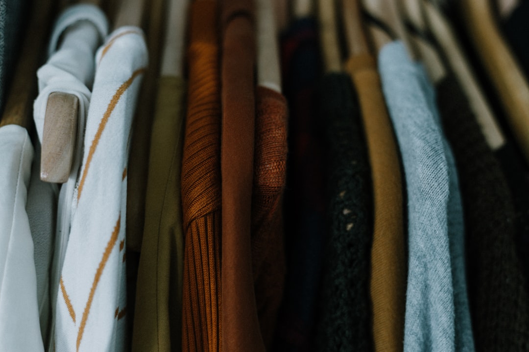 A man reviewing his wardrobe to plan a layering clothes system for London's unpredictable autumn weather.