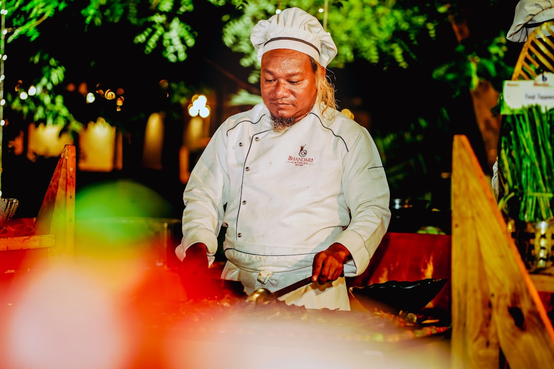 A chef serving traditional Nigerian street food at a Peckham market, representing the Nigerian community's culinary.