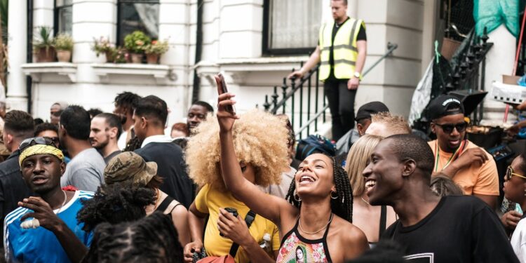 nigerian-woman-london-unsplash - LONDONwebzine A visitor from London's Nigerian community standing before a painting at a major art exhibition