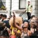 A visitor from London's Nigerian community standing before a painting at a major art exhibition