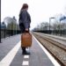 woman-arriving-train-station-platform-unsplash - LONDONwebzine A woman steps off a train at a historic British station platform, ready to begin one of her weekend escapes from London.