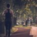woman-joining-running-club-autumn-unsplash - LONDONwebzine A smiling woman joins a running club group in a London park during autumn, wearing a light jacket and trainers.